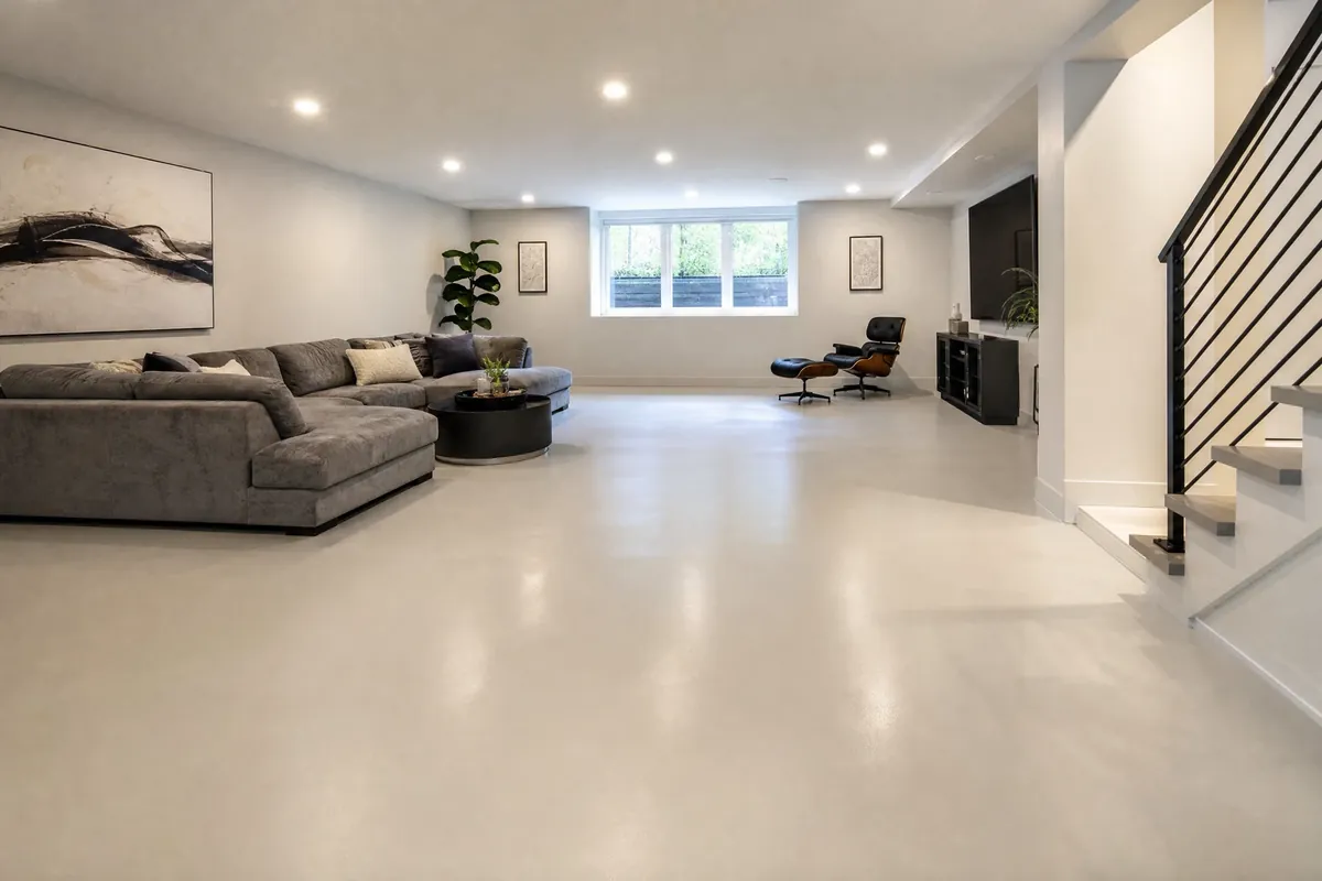 Residential basement concept with seamless light gray epoxy flooring