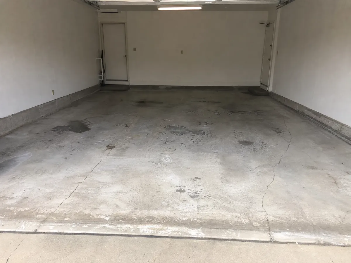 Illustrative worn concrete garage floor