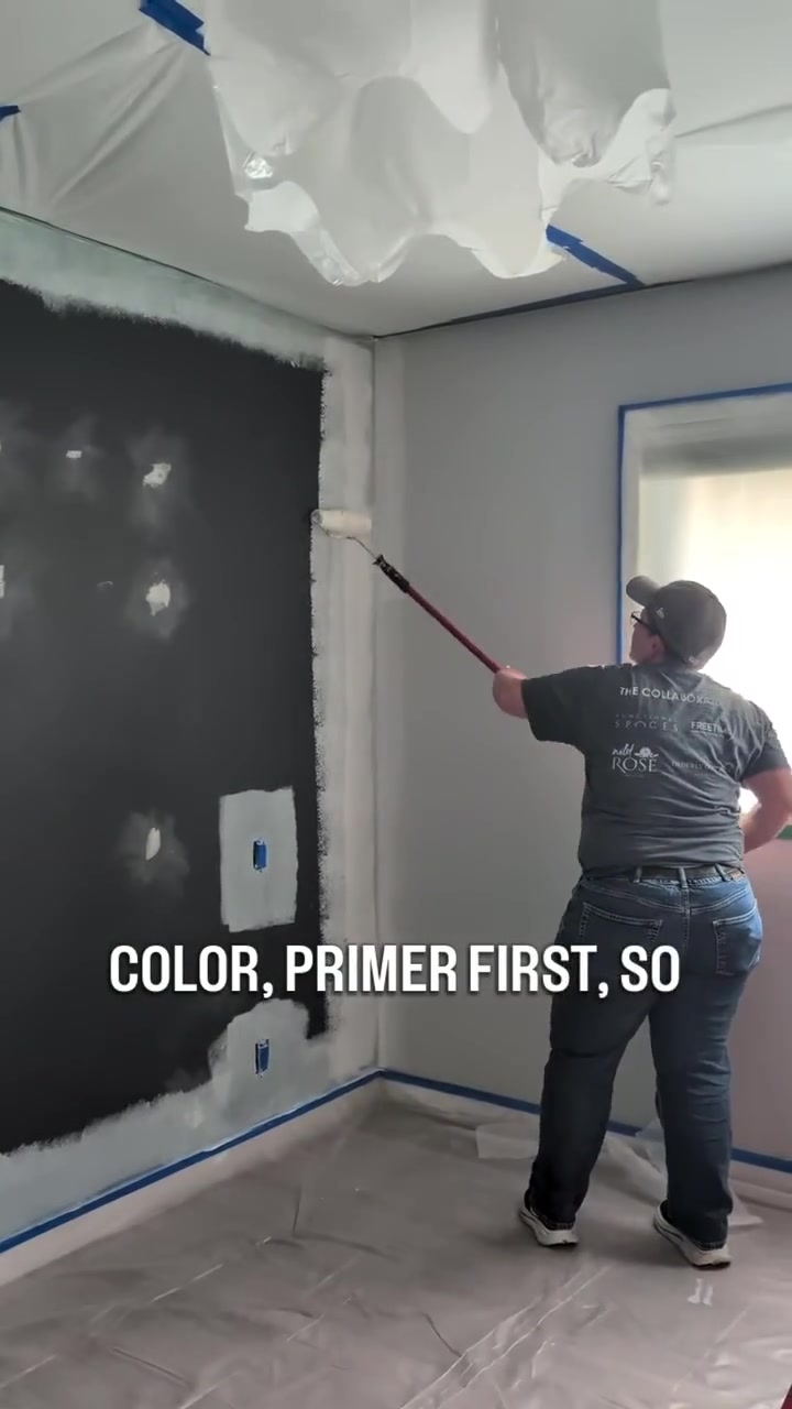 TrueForma applying light primer to a dark interior wall in a masked and protected room before spray painting