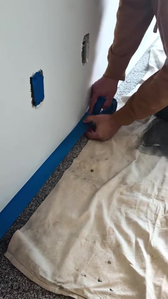 TrueForma protecting the carpet and masking along a wall before painting
